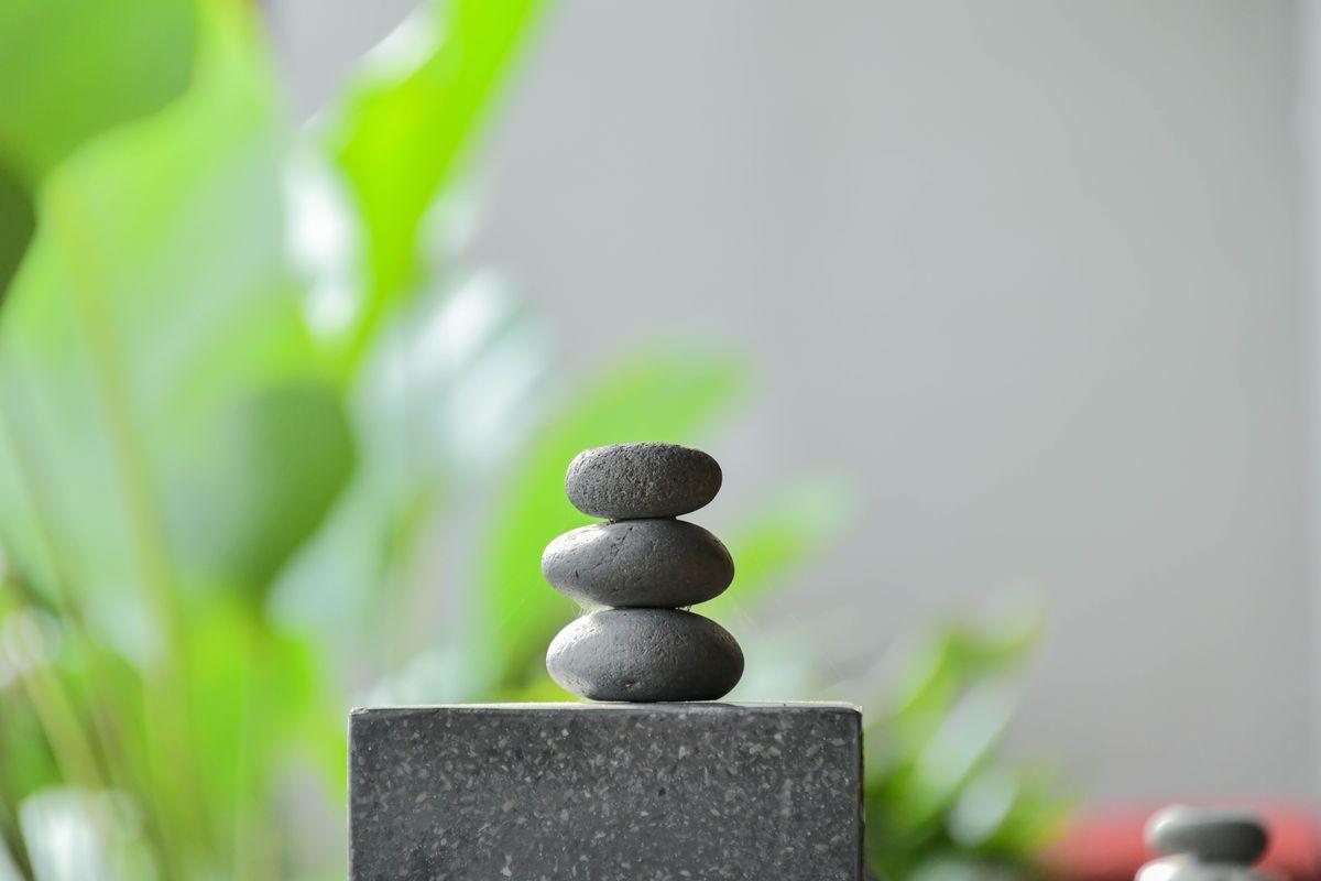 Stacked zen stones with soft greenery in the background